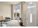 Bright living room with tall windows, neutral carpet, and an inviting sitting area at 18061 E Saskatoon Pl, Parker, CO 80134