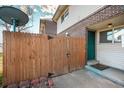 This townhouse features a gated patio, a brick facade, and a tidy walkway to the front door at 8019 Wolff # G, Westminster, CO 80031
