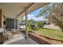 Cozy front porch with seating area offers relaxing outdoor space and scenic views at 9926 W Nova Pl, Littleton, CO 80127