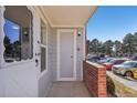 Inviting entryway of the townhome with brick accents, protected from the weather at 5550 W 80Th Pl # 1, Arvada, CO 80003
