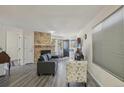 Cozy living room with a stone fireplace, new floors, and ample natural light at 5550 W 80Th Pl # 1, Arvada, CO 80003