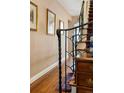 Classic foyer with hardwood floors, staircase, and elegant wrought iron railing details at 334 Ivy St, Denver, CO 80220