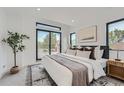 Bright bedroom featuring modern decor, plush bedding, and large windows for ample natural light at 1928 W 41St Ave, Denver, CO 80211