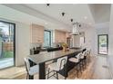 Contemporary kitchen with an extended island, stainless steel appliances, and sleek, light wood cabinetry at 1928 W 41St Ave, Denver, CO 80211