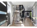 Bright foyer with a modern staircase, hardwood floors, and an open floor plan at 3453 Navajo St, Denver, CO 80211