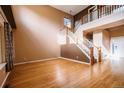 Grand foyer showcases hardwood floors, a staircase, and abundant natural light at 10154 Fairgate Way, Highlands Ranch, CO 80126