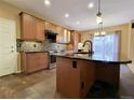 Modern kitchen featuring granite countertops, stainless steel appliances, and ample cabinet space at 10154 Fairgate Way, Highlands Ranch, CO 80126
