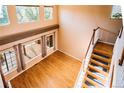 Open-concept living room with hardwood floors, vaulted ceilings, and a staircase leading to the upper level at 10154 Fairgate Way, Highlands Ranch, CO 80126