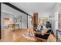 Open-concept living space with hardwood floors, exposed brick, and stylish decor at 360 S Ogden St, Denver, CO 80209