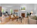 Bright living room featuring hardwood floors, a decorative fireplace, and elegant furnishings at 360 S Ogden St, Denver, CO 80209