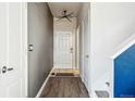 Bright entryway with hardwood floors and modern light fixture leading to the staircase at 19658 E Vassar Dr, Aurora, CO 80013