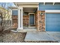 Inviting entryway with stone accents and a covered porch, creating a warm welcome at 19658 E Vassar Dr, Aurora, CO 80013