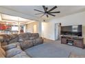 Comfortable living room featuring a large sectional sofa, neutral carpet, and open access to the kitchen at 14050 W 8Th Ave, Golden, CO 80401