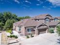 An aerial view of a lovely home with mature trees and landscaping, including a view of the attached garage at 14916 E Crestridge Pl, Centennial, CO 80015