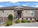 Inviting entrance with stone accents, a decorative door, and landscaped planters enhancing curb appeal at 14916 E Crestridge Pl, Centennial, CO 80015