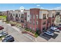 Multi-story condo building with brick accents, balconies, and loading zone at 307 Inverness S Way # 307, Englewood, CO 80112