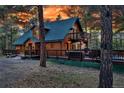 Charming two-story home with a wraparound deck offers ample space for outdoor living at 36920 Forest Trl, Elizabeth, CO 80107