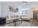 Comfortable living room with high ceiling, large windows providing natural light, neutral-toned furniture and a decorative rug at 5985 S Valdai Way, Aurora, CO 80015