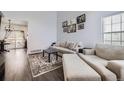 Bright living room featuring a comfortable seating arrangement and an decorative rug for a cozy atmosphere at 5985 S Valdai Way, Aurora, CO 80015