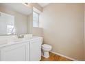 Small bathroom with white vanity and toilet at 10219 Vine Ct, Thornton, CO 80229