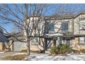 Two-story townhome featuring stone facade and attached garage at 10219 Vine Ct, Thornton, CO 80229