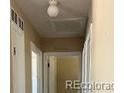 Hallway with neutral walls and door frames leading to other rooms in the home at 804 S 1St Ave, Brighton, CO 80601