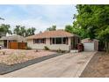 Cozy home with a large driveway, detached garage, and low-maintenance xeriscape front yard at 5635 Nebraska Way, Denver, CO 80224