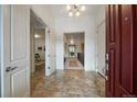 Inviting foyer with tile flooring, an open view to the upper level, and a classic red door at 10632 Star Thistle Ct, Highlands Ranch, CO 80126