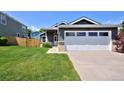 Gray single-Gathering home with a two-car garage, complemented by a lush lawn and inviting curb appeal at 690 W Jamison Cir, Littleton, CO 80120