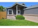 Inviting covered front porch featuring a bench and manicured landscaping, enhancing curb appeal at 690 W Jamison Cir, Littleton, CO 80120