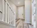 Bright entryway featuring wood-look flooring, white trim, and staircase access at 9660 Browns Peak Cir, Littleton, CO 80125
