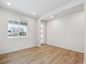 Bright foyer with light wood flooring and view to the front door at 1382 Rock Cliff Ave, Erie, CO 80516