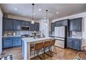 Beautiful kitchen with blue cabinets, an island with seating, and stainless-steel appliances at 7470 Blue Water Ln, Castle Rock, CO 80108