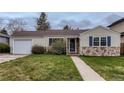 Charming single-story home with stone accents, well-maintained lawn, and attached one car garage in established neighborhood at 2965 S Birch St, Denver, CO 80222