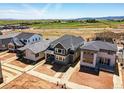 New construction homes with well-maintained yards in a neighborhood with scenic views of green fields and mountains at 7291 Prairie Sage Pl, Littleton, CO 80125