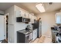 Efficient kitchen with stainless steel appliances and tile flooring at 15139 E Wesley Ave, Aurora, CO 80014