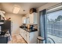 Functional kitchen with granite countertops and access to outdoor patio at 15139 E Wesley Ave, Aurora, CO 80014