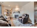 Cozy living room featuring a brick fireplace and comfortable seating at 15139 E Wesley Ave, Aurora, CO 80014
