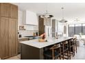 Elegant kitchen featuring a large island, marble countertops, and modern appliances at 3932 Kalamath St, Denver, CO 80211