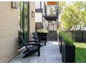 Outdoor patio space with sleek black chairs and modern planter boxes at 3932 Kalamath St, Denver, CO 80211