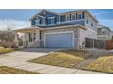 Charming two-story home featuring stone accents, a covered porch, and an attached two-car garage at 15786 Randolph Pl, Denver, CO 80239