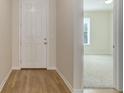 Bright foyer featuring hardwood floors and a view into a carpeted living space at 1462 Raindrop Way, Castle Rock, CO 80109