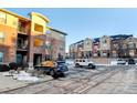 Apartment building with parking and neighboring building at 4100 Albion St # 504, Denver, CO 80216