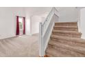 Inviting carpeted staircase leading to the upper level of the home with neutral decor at 12825 Forest Way, Thornton, CO 80241