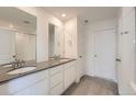 Bathroom featuring double sinks, gray counters, white cabinets, and a tiled floor at 2080 S Haleyville Way, Aurora, CO 80018