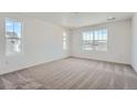 Bright bedroom featuring neutral carpet, white walls, recessed lighting, and multiple windows for ample natural light at 2080 S Haleyville Way, Aurora, CO 80018