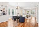 Open concept living and dining area boasts hardwood floors, ample natural light, and stylish furnishings at 4603 W 33Rd Ave, Denver, CO 80212