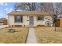 House exterior featuring a walkway and well-maintained lawn at 4825 Estes St, Arvada, CO 80002