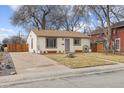 Front view of a Ranch home with a driveway and landscaping at 4825 Estes St, Arvada, CO 80002