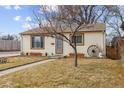 Charming Ranch home with a tree in front and a small yard at 4825 Estes St, Arvada, CO 80002